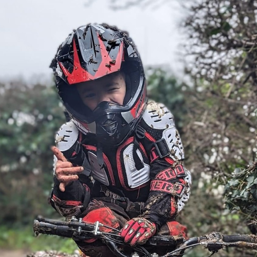  Boy wearing a red and black Wulfsport helmet 